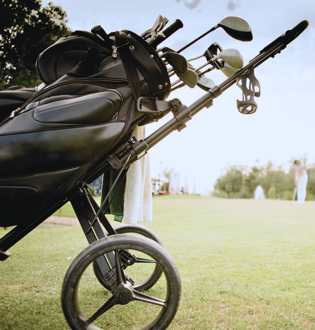 Golf Bag with Clubs on Green Field - Edited